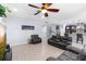 Open living area showcasing tile flooring, comfortable seating, and seamless flow to the modern kitchen at 1204 Lexington Ave, Davenport, FL 33837