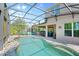 Screened pool with patio area, outdoor kitchen and lounge seating at 1204 Lexington Ave, Davenport, FL 33837
