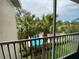 Balcony view overlooking a pool and palm trees providing a private tropical feel at 1224 S Hiawassee Rd # 638, Orlando, FL 32835