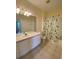 Bright bathroom featuring a single vanity, toilet, mirror, and a shower with a decorative curtain at 1224 S Hiawassee Rd # 638, Orlando, FL 32835
