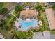 Aerial view of the community pool, lush landscaping, and clubhouse at 1227 Sandwedge St, Davenport, FL 33896