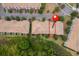 An aerial view showing the property nestled among lush greenery and neighboring townhomes in a well-maintained community at 1227 Sandwedge St, Davenport, FL 33896