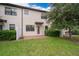 View of the backyard patio with lush landscaping and green grass at 1227 Sandwedge St, Davenport, FL 33896