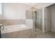 Bright bathroom featuring a tiled shower and a soaking tub at 1227 Sandwedge St, Davenport, FL 33896