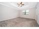 Spacious bedroom features carpet floors, ceiling fan, and a tray ceiling at 1227 Sandwedge St, Davenport, FL 33896
