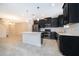 Modern kitchen with stainless steel appliances, white countertops, and sleek black cabinets at 1227 Sandwedge St, Davenport, FL 33896
