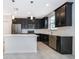Contemporary kitchen featuring black cabinets, stainless steel appliances, and white countertops at 1227 Sandwedge St, Davenport, FL 33896