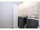 Laundry room with a washer, dryer, and wire shelving at 1227 Sandwedge St, Davenport, FL 33896