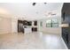 Open living space with tile flooring, black cabinets, and stainless steel appliances at 1227 Sandwedge St, Davenport, FL 33896