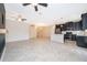 Spacious living area showcasing tile floors, black kitchen cabinets, and a modern design at 1227 Sandwedge St, Davenport, FL 33896
