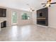 Well-lit living room with tile floors, a modern fireplace, and a view to the patio at 1227 Sandwedge St, Davenport, FL 33896