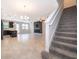 Bright living room with staircase, tile flooring, and modern fireplace at 1227 Sandwedge St, Davenport, FL 33896