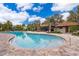 Community pool with lounge chairs and palm trees at 1227 Sandwedge St, Davenport, FL 33896