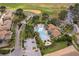Aerial view of a community pool with a uniquely shaped pool, palm trees, a spa, and parking at 1227 Sandwedge St, Davenport, FL 33896