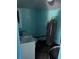 Small blue bathroom showing a toilet, sink, water heater, and some staining on the floor at 1231 Leon Ln, Daytona Beach, FL 32117
