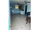 Unfinished room showing a ceiling fan, cabinets, window, tiled flooring, and some trash at 1231 Leon Ln, Daytona Beach, FL 32117