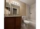 Bathroom with a combination bathtub/shower, toilet, and granite-look sink vanity at 12512 Wisconsin Woods Ln, Orlando, FL 32824