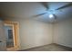 Bright bedroom featuring a ceiling fan and view into the next room at 12512 Wisconsin Woods Ln, Orlando, FL 32824