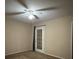 This bedroom features a ceiling fan and door leading to outside at 12512 Wisconsin Woods Ln, Orlando, FL 32824