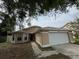 Tan single-Gathering home with a white garage door and bay window at 12512 Wisconsin Woods Ln, Orlando, FL 32824