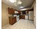 Spacious kitchen with tile flooring, wood cabinetry, and white appliances at 12512 Wisconsin Woods Ln, Orlando, FL 32824