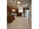 Kitchen with granite counters, brown cabinets, and white appliances at 12512 Wisconsin Woods Ln, Orlando, FL 32824