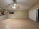 Spacious living room features neutral paint and tile flooring at 12512 Wisconsin Woods Ln, Orlando, FL 32824