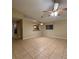 Spacious living room features neutral paint and tile flooring, and opens to the kitchen at 12512 Wisconsin Woods Ln, Orlando, FL 32824