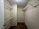 Walk-in closet with wire shelving for storage and organization at 12512 Wisconsin Woods Ln, Orlando, FL 32824