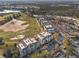 An aerial view of condo buildings beside a pristine golf course, green spaces, and parking at 1370 Centre Court Ridge Dr # 204, Reunion, FL 34747