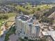 A beautiful building with a rooftop pool is nestled alongside a well-manicured golf course and other greenery at 1370 Centre Court Ridge Dr # 204, Reunion, FL 34747