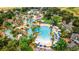 Lush tropical landscaping around the large pool area with lounge chairs and shaded seating at 1370 Centre Court Ridge Dr # 204, Reunion, FL 34747