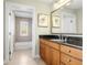 Bathroom with a granite countertop, wood cabinets, and tiled shower and tub at 1370 Centre Court Ridge Dr # 204, Reunion, FL 34747
