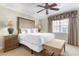 Cozy bedroom with a comfortable bed, side tables, and a bench at 1370 Centre Court Ridge Dr # 204, Reunion, FL 34747