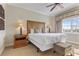 Comfortable bedroom with a king-size bed, elegant lighting, and views of the exterior landscape at 1370 Centre Court Ridge Dr # 204, Reunion, FL 34747