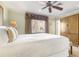 Bright bedroom with a large window and a wooden wardrobe with bench seating at 1370 Centre Court Ridge Dr # 204, Reunion, FL 34747