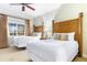 Bedroom with two queen beds, decorative lamps, and a ceiling fan at 1370 Centre Court Ridge Dr # 204, Reunion, FL 34747