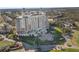 Elevated exterior of a beautiful resort building with lush landscaping, golf course, and ample parking at 1370 Centre Court Ridge Dr # 204, Reunion, FL 34747