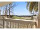 View of golf course through the columns of the balcony showing green and sand traps beneath a clear blue sky at 1370 Centre Court Ridge Dr # 204, Reunion, FL 34747
