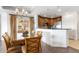 Kitchen area with wood cabinets, stainless appliances, and a decorative dining table and chairs at 1370 Centre Court Ridge Dr # 204, Reunion, FL 34747