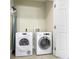 Laundry room featuring a stacked washer and dryer, with an ironing board, and tile flooring at 1370 Centre Court Ridge Dr # 204, Reunion, FL 34747