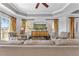 Bright living room featuring a modern entertainment center and stylish armchairs with views of the golf course at 1370 Centre Court Ridge Dr # 204, Reunion, FL 34747