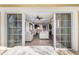 Open-concept living room with hardwood floors and sliding glass doors leading to balcony at 1370 Centre Court Ridge Dr # 204, Reunion, FL 34747