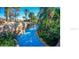 A tranquil flowing pool with waterfalls surrounded by lush greenery for a private escape at 1370 Centre Court Ridge Dr # 204, Reunion, FL 34747