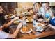 Group enjoys variety of delicious foods at the restaurant on a wooden table at 1370 Centre Court Ridge Dr # 204, Reunion, FL 34747