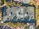Aerial view of tennis courts surrounded by trees, landscaping, and parking spaces in a well-maintained community at 1370 Centre Court Ridge Dr # 204, Reunion, FL 34747