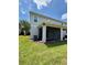 Back exterior view showcasing a screened-in patio and backyard perfect for outdoor relaxation and enjoyment at 141 Mitchell Creek Way, Oviedo, FL 32765