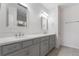 Bathroom features dual sinks, quartz counters, and gray cabinets at 141 Mitchell Creek Way, Oviedo, FL 32765