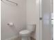 Half bathroom with a toilet, towel rack and paper holder, featuring neutral tones and practical design at 141 Mitchell Creek Way, Oviedo, FL 32765