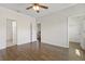 Bedroom featuring wood flooring, fan, white walls, and an open door at 141 Mitchell Creek Way, Oviedo, FL 32765